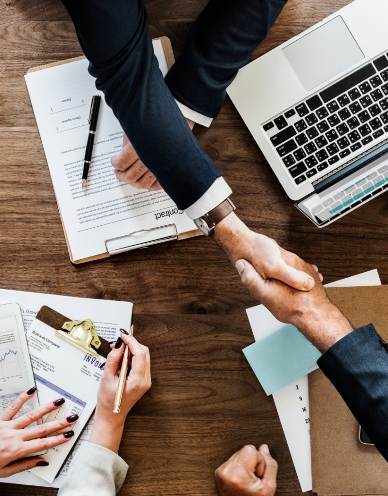 business-people-shaking-hands-together 1